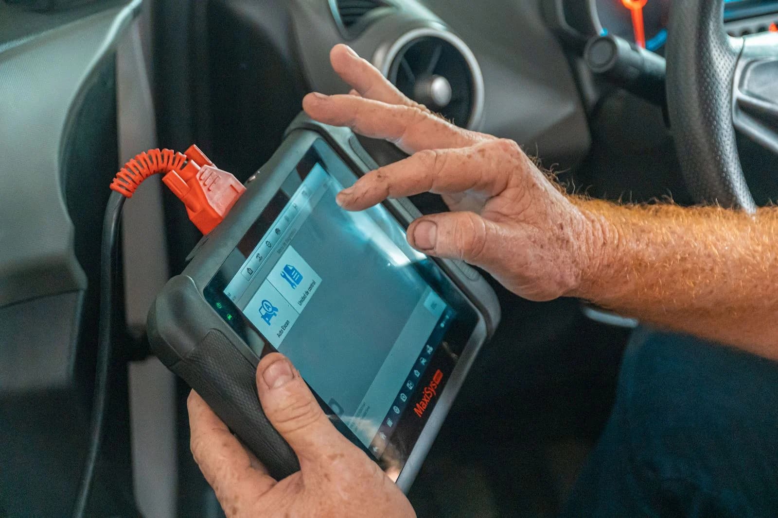 Technician operating an ADAS diagnostic scan tool